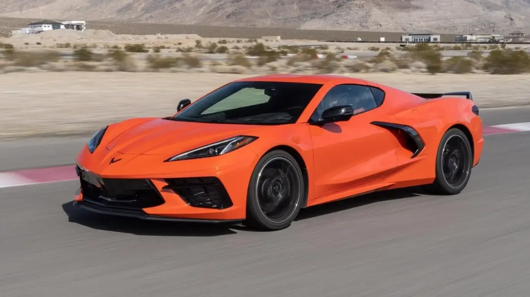 شورولت کوروت (Chevrolet Corvette) نارنجی‌رنگ در حال حرکت سریع در پیست مسابقه