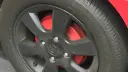 ترمز کاسه‌ای (Drum Brake) قرمز رنگ در پشت رینگ مشکی خودرو