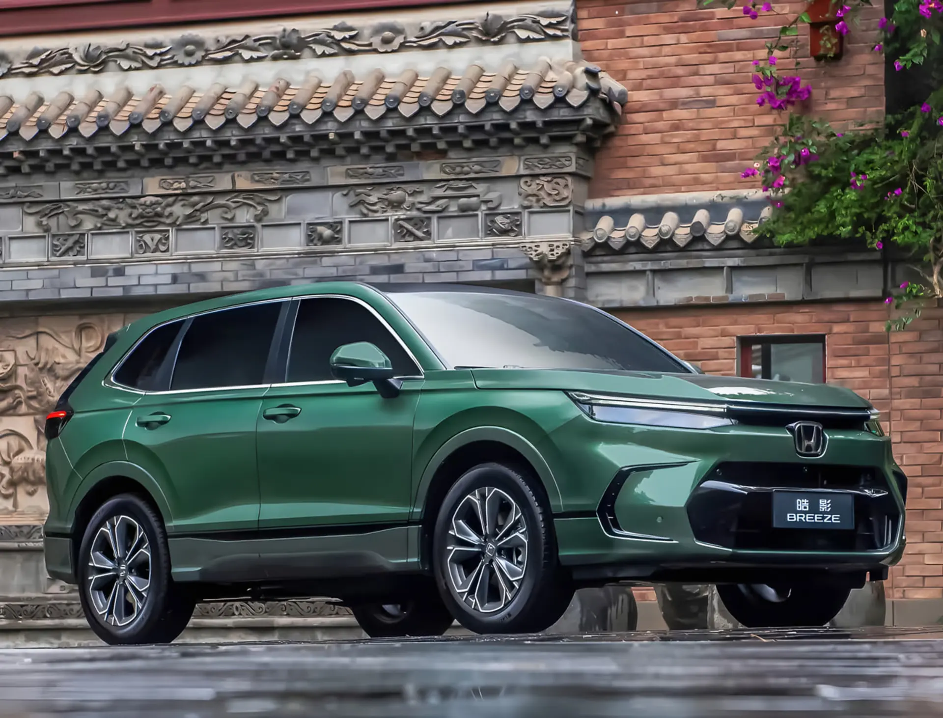 خودرو هوندا بریز (Honda Breeze) با رنگ سبز متالیک در مقابل یک ساختمان سنتی