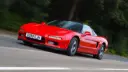 خودرو اسپرت هوندا (Honda) NSX قرمز در حال حرکت در جاده