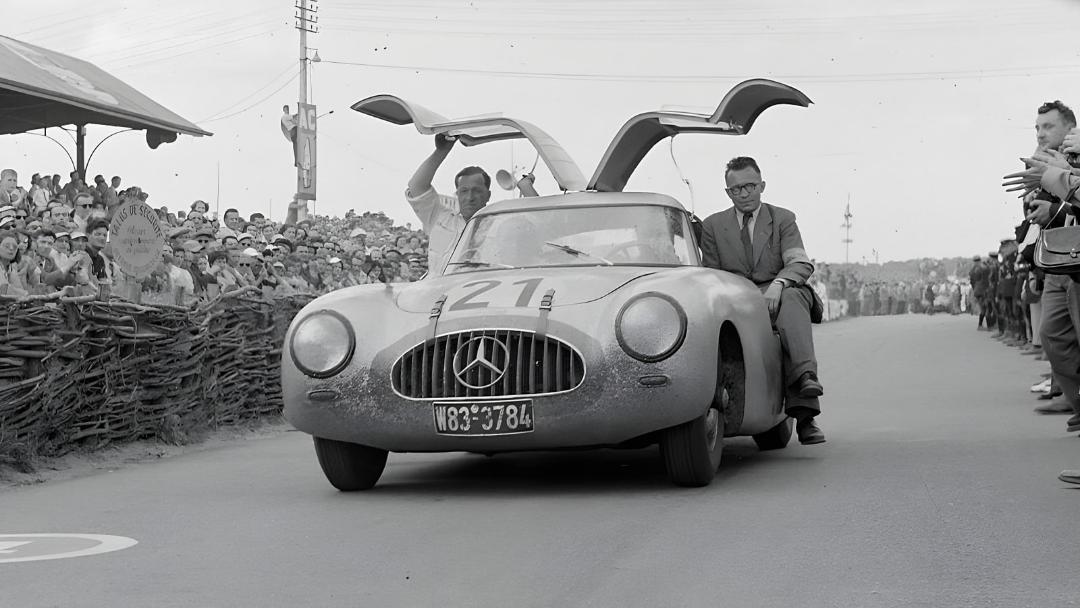 خودروی مرسدس بنز 300 SL (Mercedes-Benz 300 SL) با درهای گنگنام باز در پیست مسابقه