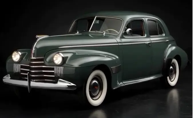 خودروی کلاسیک اولدزموبیل (Oldsmobile) مدل ۱۹۴۰ با رنگ سبز تیره و لاستیک‌های سفید