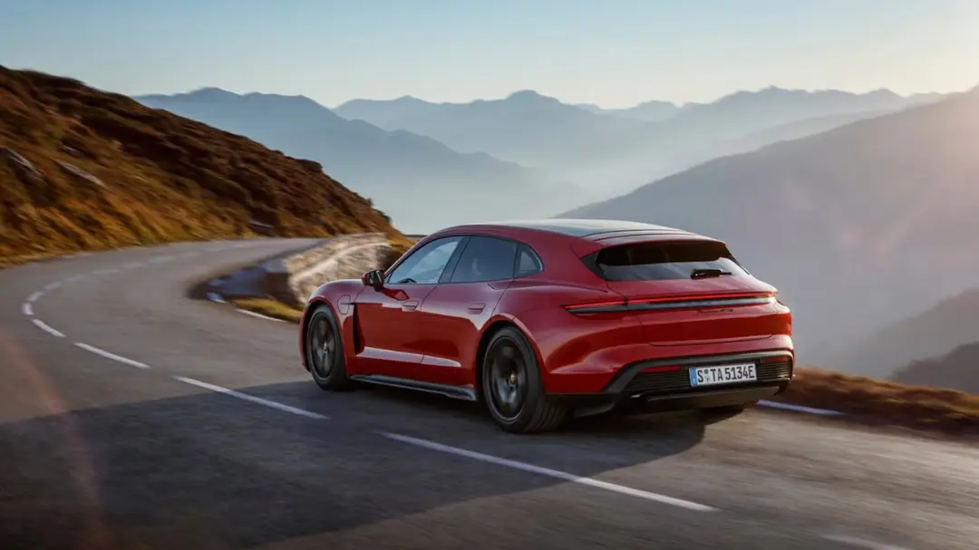 خودرو قرمز پورشه (Porsche) در حال حرکت در جاده کوهستانی