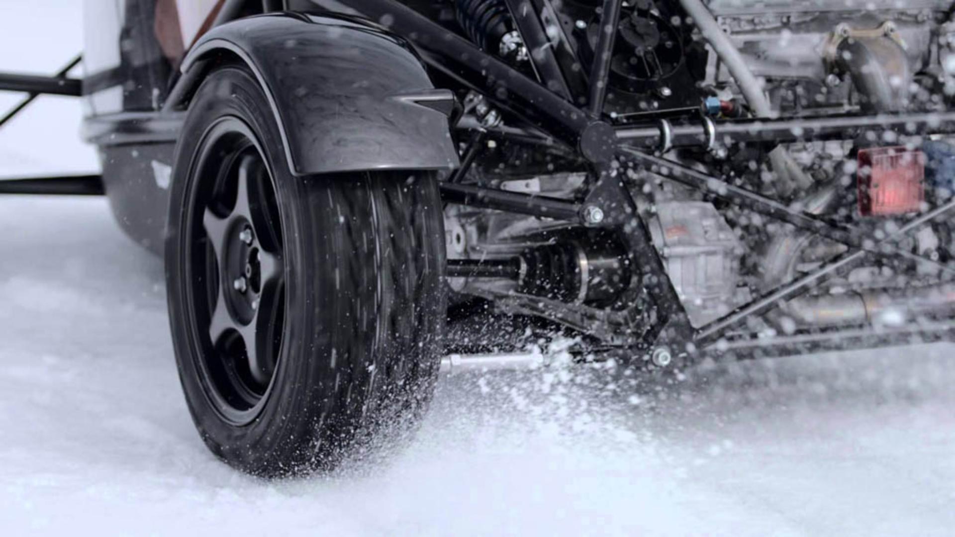 ariel-atom-on-studded-tires-takes-on-snowmobile 01