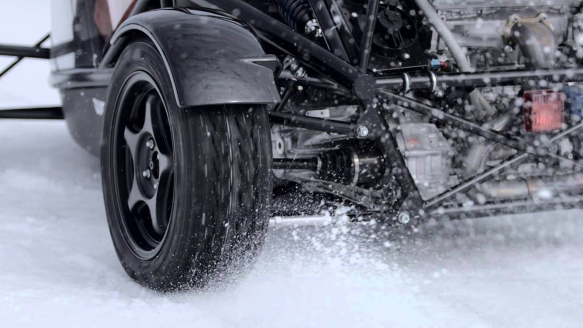 ariel-atom-on-studded-tires-takes-on-snowmobile 01