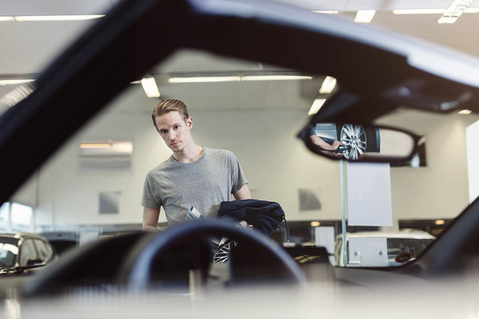Man examining car in store