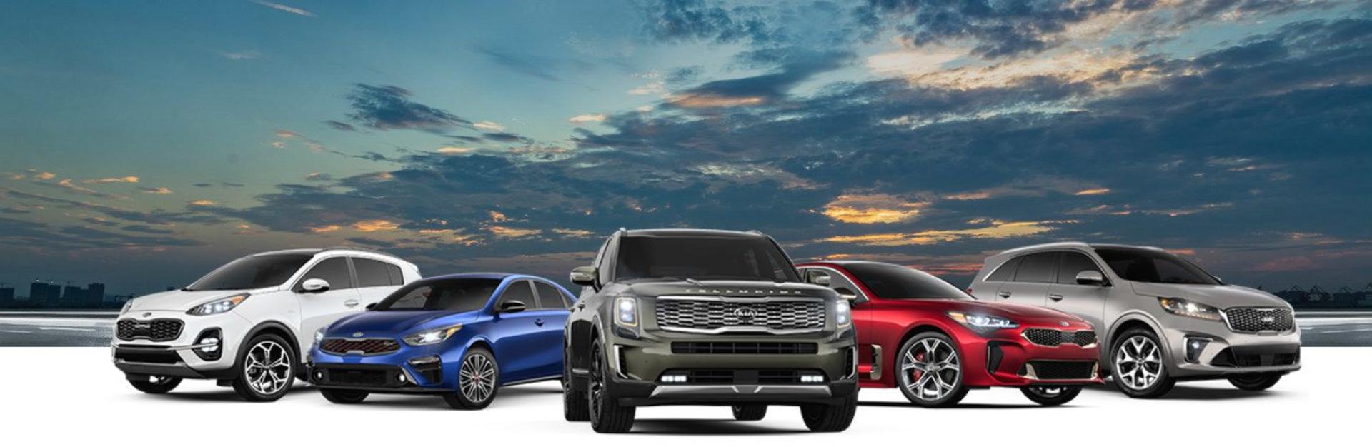 2020_Kia_model_lineup_in_front_of_a_port_view_at_sunset_o