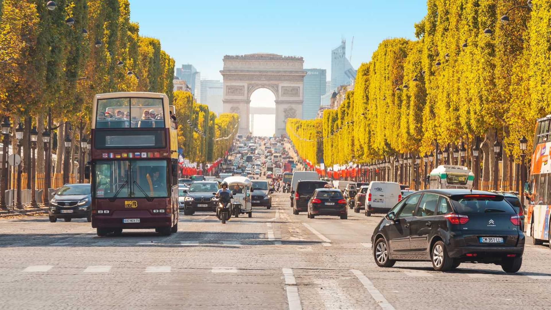 buses-and-cars-drive-along-avenue-champs-elysees-in-paris-france