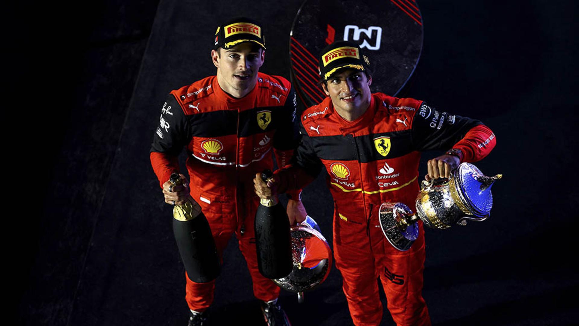BAHRAIN, BAHRAIN - MARCH 20: Race winner Charles Leclerc of Monaco and Ferrari and Second placed Carlos Sainz of Spain and Ferrari celebrate on the podium during the F1 Grand Prix of Bahrain at Bahrain International Circuit on March 20, 2022 in Bahrain, Bahrain. (Photo by Mark Thompson/Getty Images)