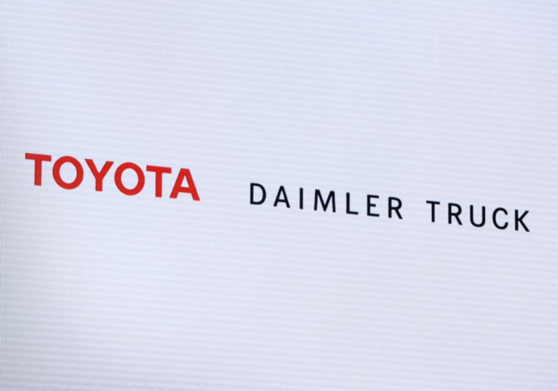 Logos of Toyota Motor Corp and Daimler Truck are pictured at their joint news conference in Tokyo, Japan, May 30, 2023. REUTERS/Kim Kyung-Hoon