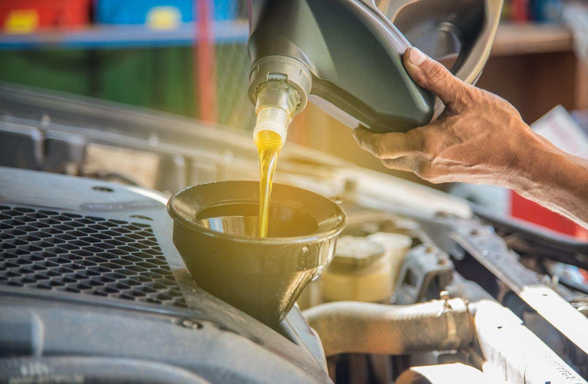 man-pouring-oil-into-car-royalty-free-image-1598901693