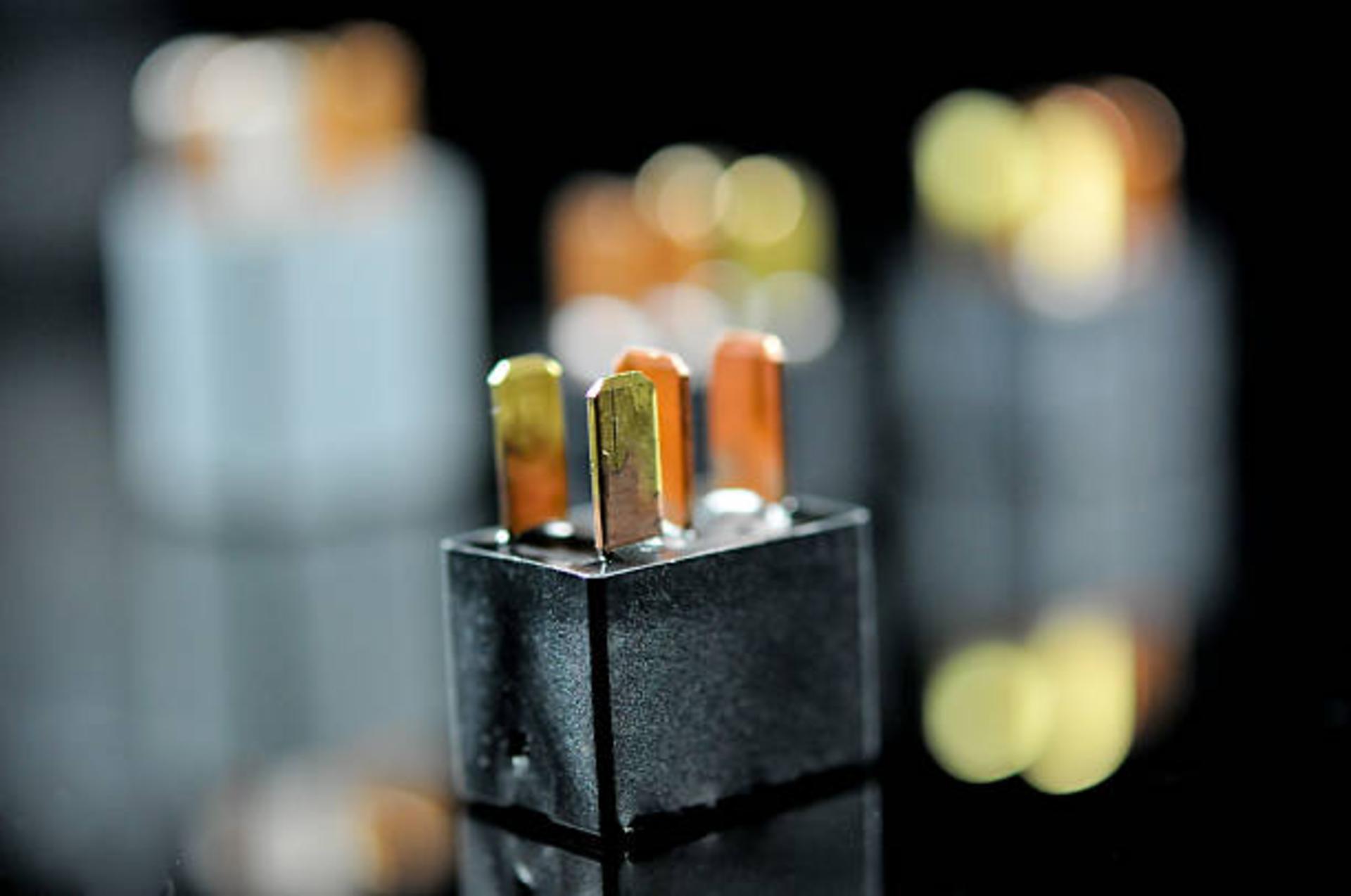 Auto electronic collection on black background. Car electromagnetic relay switch. Car automotive sensor, bokeh
