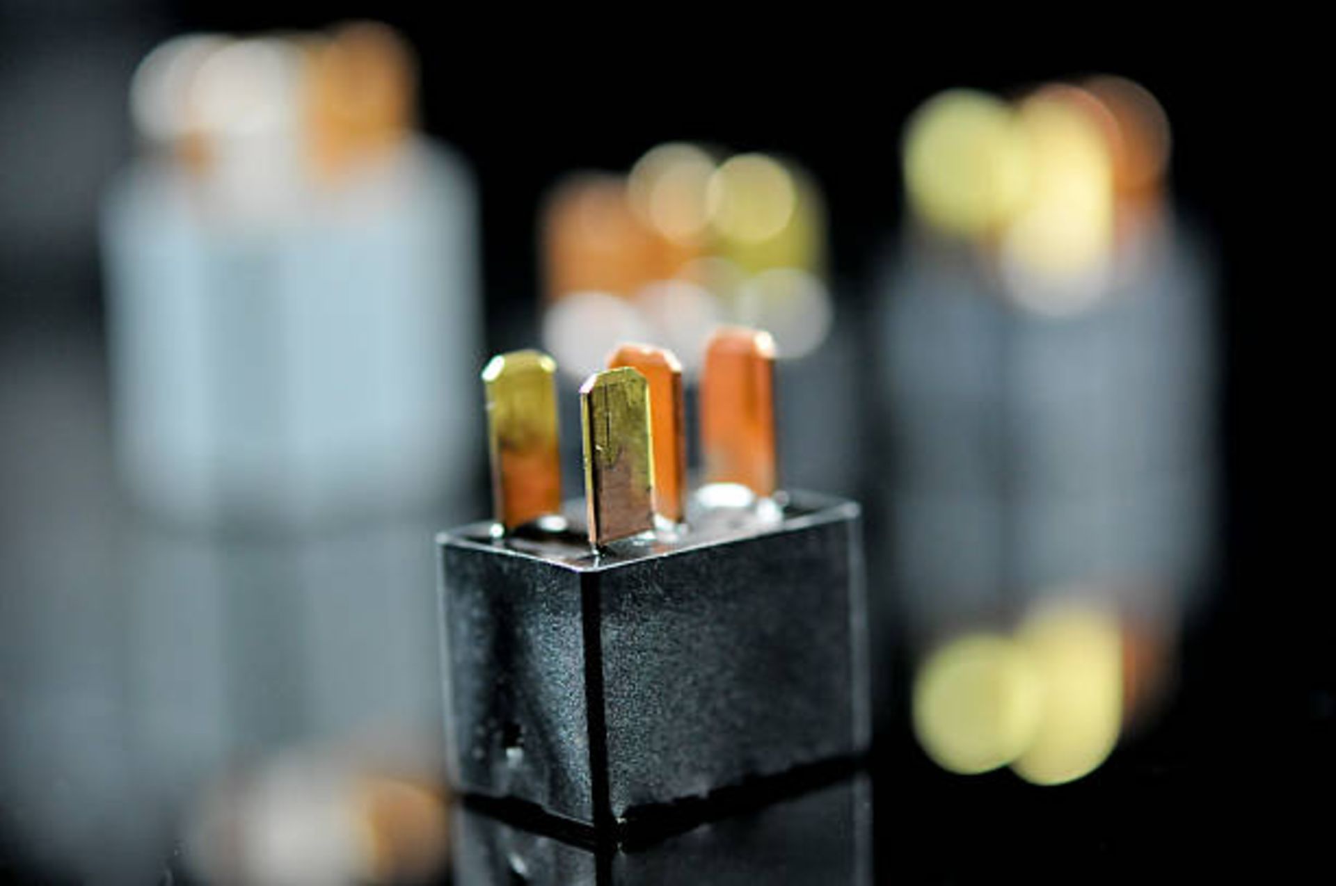 Auto electronic collection on black background. Car electromagnetic relay switch. Car automotive sensor, bokeh