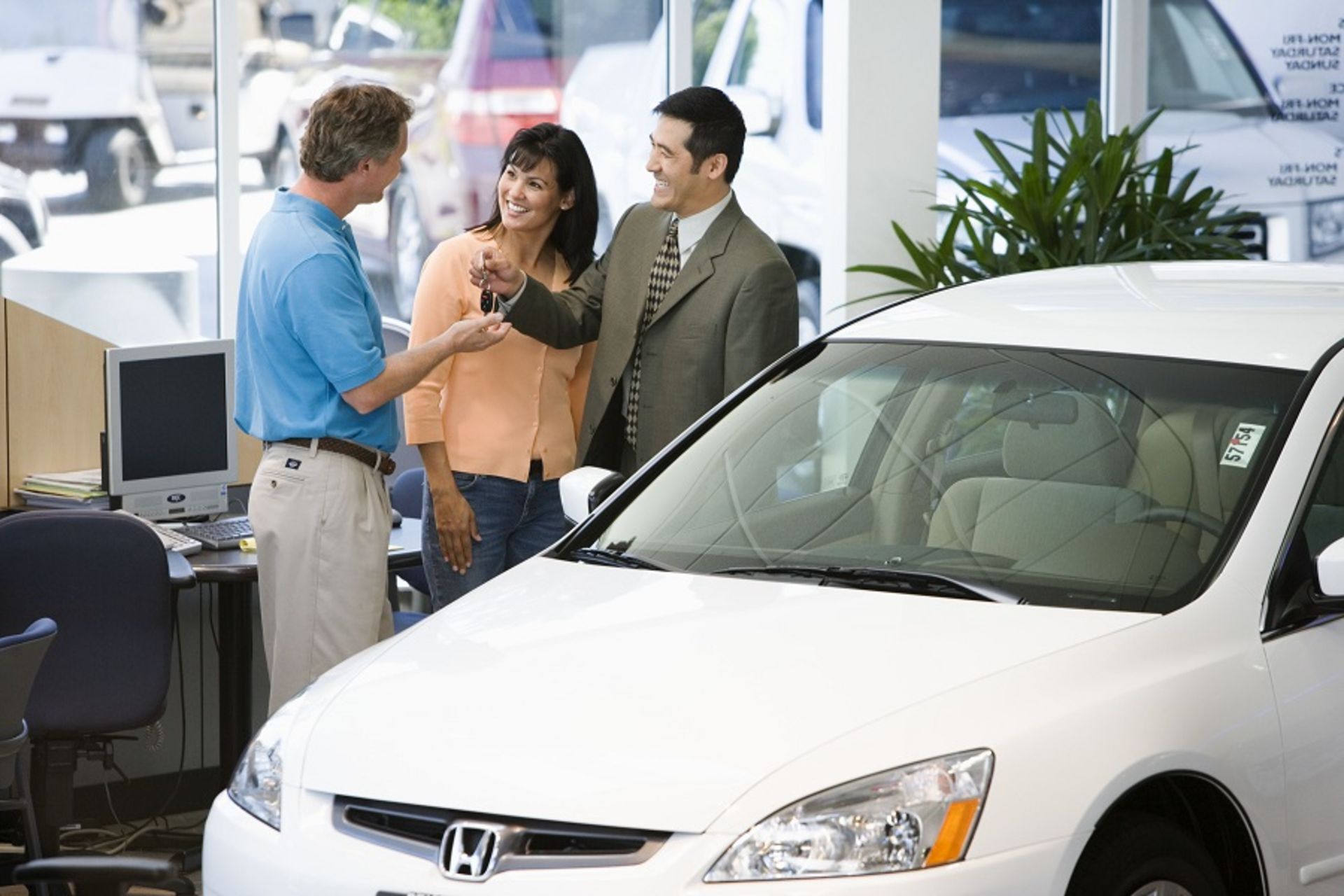 car-salesman-handing-over-keys-royalty-free-image-1594044957