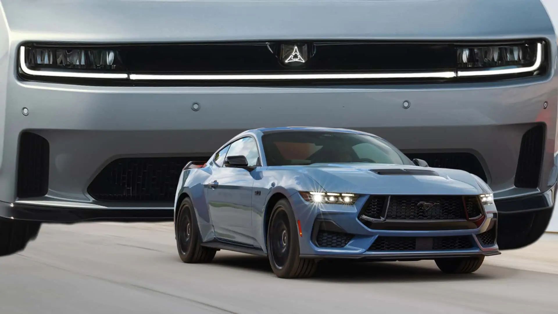 ford-mustang-driving-on-a-road-while-a-clownishly-large-charger-looms-in-the-background