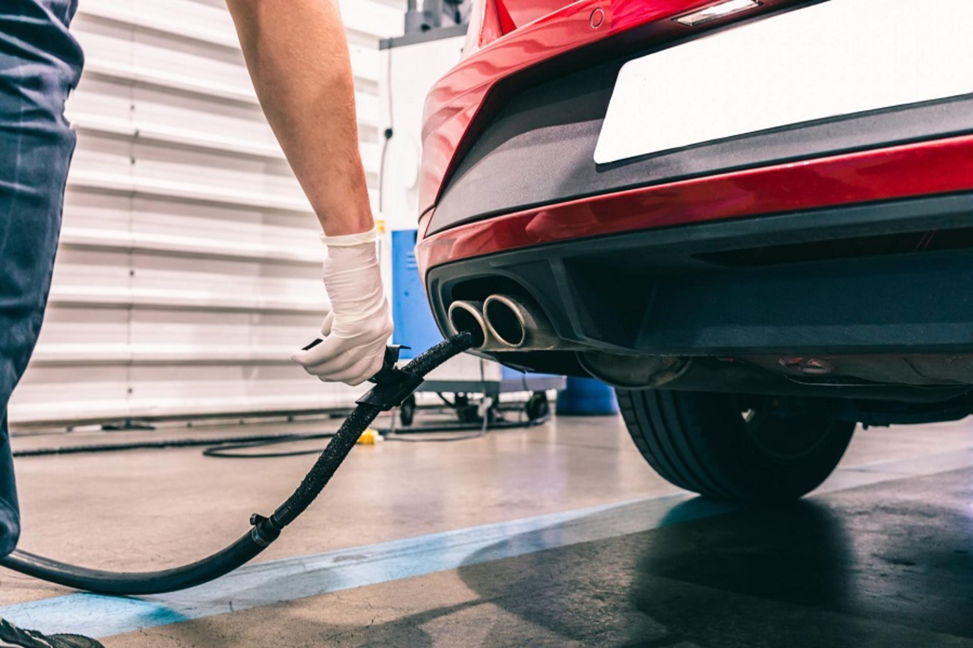 A technician doing an emission control of a security inspection