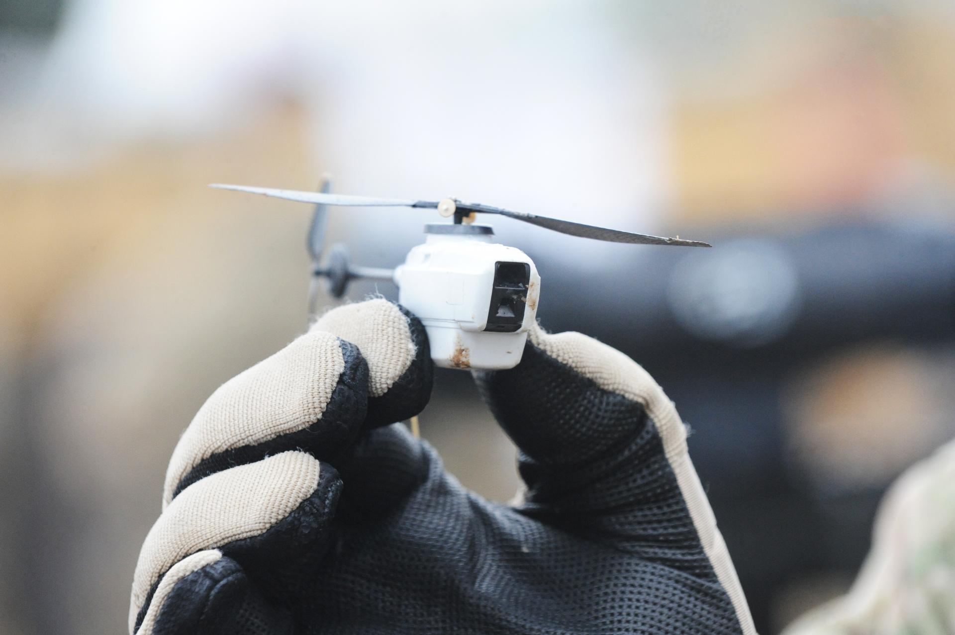 A Black Hornet nano helicopter unmanned aerial vehicle (UAV).

The Black Hornet Nano Unmanned Air Vehicle measures around 4 inches by 1 inch (10cm x 2.5cm) and provides troops on the ground with vital situational awareness.

The Black Hornet is equipped with a tiny camera which gives troops reliable full-motion video and still images. Soldiers are using it to peer around corners or over walls and other obstacles to identify any hidden dangers and the images are displayed on a handheld terminal.